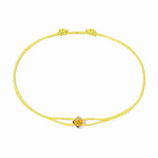 Le Cube cord bracelet in yellow gold with yellow sapphire
